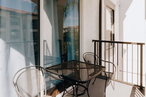 Enjoy dining or socializing on the balcony with a table and chairs.