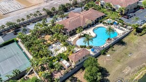 An aerial view of a resort with a swimming pool, tennis courts, and multiple buildings. - Oakwater - Spacious 3BR 2.5BA townhome, gated (Kissimmee)