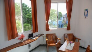A room with a wooden desk, a laptop, a chair, and a dining table with chairs. - 2 Blocks from ADO station + free bikes (Tulum)