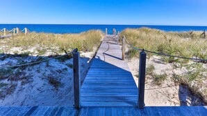 A wooden boardwalk leading to the beach with a clear view of the ocean. - Waterfront cottage with private beach in Sandwich! 179B North Shore Blvd (Sandwich)
