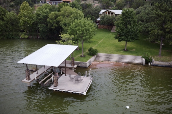 Aerial view of the boat dock, steps leading into the lake  and swimming area.