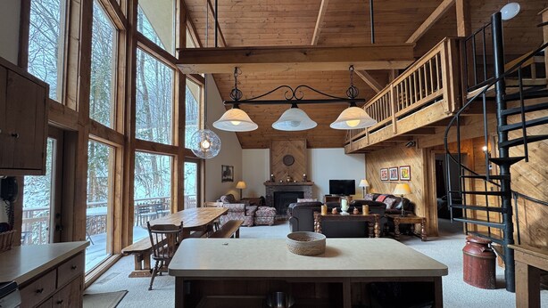 A spacious kitchen with a central island, large windows, and a lofted dining area. - Ski-in Ski-out Killington Chalet on Great Eastern Trail, Huge Loft + 4 Bedrooms (Killington)