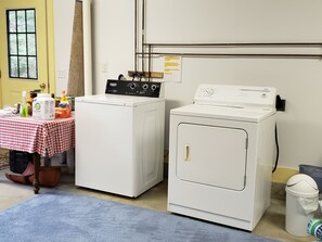 Convenient laundry facilities feature two front-loading washing machines and ample storage for cleaning supplies.