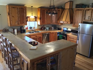 Enjoy cooking in this well-equipped kitchen with a central island, gas stove, and dishwasher.