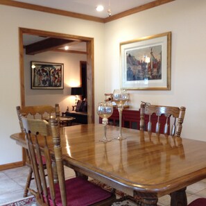 A dining room with a wooden table, chairs, and a framed picture on the wall. - Island Lake Redwood Cottage With Canoe and Grill:  Relax, Swim, Fish, Ski, Enjoy (Fort McCoy)