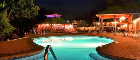 Relax by the pool surrounded by lounge chairs and a covered seating area.