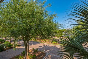Surrounded by lush trees and shrubs, this serene outdoor space features a beautifully paved area.