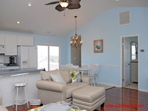 Relax in this inviting living space with a kitchen, dining area, and comfortable seating.