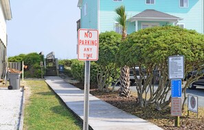 A no parking sign, a beach access sign, and a littering fine sign along a sidewalk. - Flip Flops - Cozy 2nd Row Home - Ocean Views! (Surf City)
