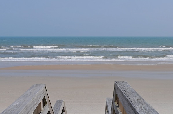 A beach with wooden barriers and a clear view of the ocean. - Flip Flops - Cozy 2nd Row Home - Ocean Views! (Surf City)