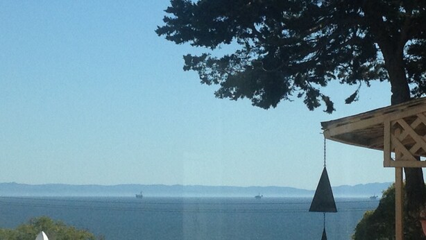 A coastal view with a clear sky, a hanging light fixture, and distant ships on the water. - MAGICAL 5-STAR RATED OCEAN VIEW CUSTOM HOME - PLEASE READ ALL 400 GUEST REVIEWS! (Summerland)