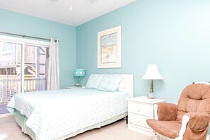 A bedroom with a bed, a nightstand, a chair, a window with curtains, and a framed picture on the wall. - Hoos at the Beach - Lovely 4 BR Sea Star Village Townhouse; Ocean View! (Surf City)