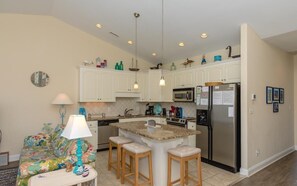 Enjoy cooking in this well-equipped kitchen with a central island and dining area.