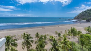 A beach with palm trees and a view of the ocean. - The best condo in Jaco Beach, just got A LOT BETTER!
 (Jaco)