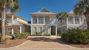 A two-story house with a covered front porch and a balcony on the second floor. - The fun begins at the Flip Flop Inn! - FREE Beach Serv-In Season- 4 min to Gulf! (Miramar Beach)