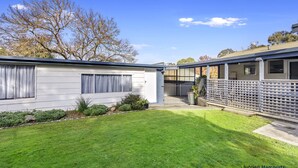 A single-story house with a covered patio, a fenced backyard, and a well-maintained lawn. - Room for the whole family (Eildon)