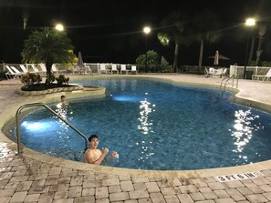 A swimming pool with a 3 ft 6 in depth sign, surrounded by lounge chairs and palm trees. -  Disney's attractions while staying at an affordable resort and pet friendly!  (Kissimmee)