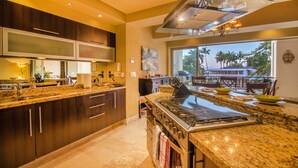 A modern kitchen with granite countertops, stainless steel appliances, and a large island. - Molino de Agua BEST in PV, amazing location. best pool!  Walk EVERYWHERE (Puerto Vallarta)