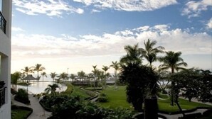 A resort with a pool, palm trees, and a clear sky. - Molino de Agua BEST in PV, amazing location. best pool!  Walk EVERYWHERE (Puerto Vallarta)