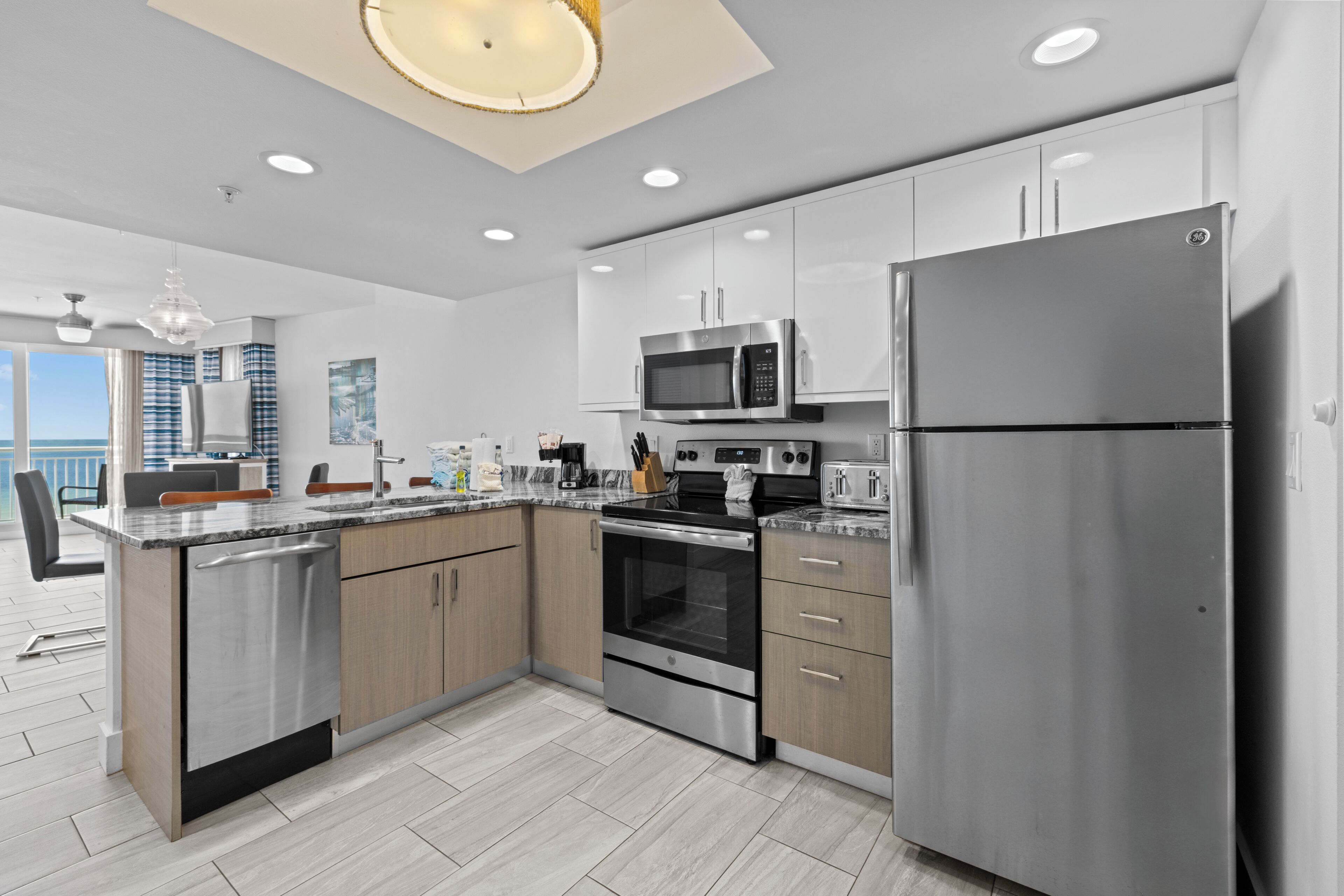 A modern kitchen with stainless steel appliances, wooden cabinets, and a large island.