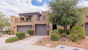 A modern two-story house with a garage, a covered patio, and a landscaped garden with various shrubs and a tree. - Poolside 3BR w/ Loft & 2 Kings on the 18th Green (St. George)