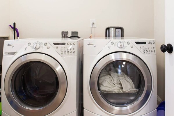 Two front-loading washing machines in a laundry room.