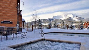 A wooden building labeled "Gathering Place" with a hot tub and outdoor seating area.