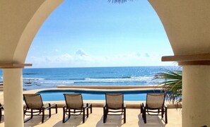 A poolside view with chairs and a clear ocean view. - Georgous 4 bedroom-4.5 bath Oceanfront Villa - Tulum- Oceanside Priv. Pool. (Chemuyil)