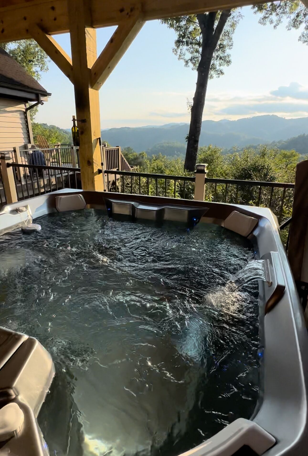 A hot tub with a view of mountains.