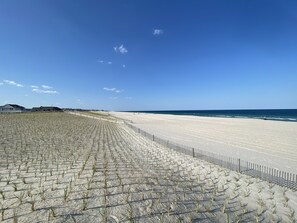 A sandy beach with a wooden fence and a clear blue sky. - Lavallette Gorgeous 3 Bed/2 Bath Beach Block Rental-Beach Access Street, Badges (Lavallette)