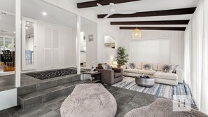 A modern living room with a sofa, coffee table, and decorative pillows.