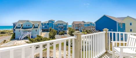 A coastal residential area with houses featuring balconies and a wooden deck.