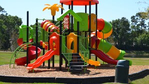 A playground with multiple slides and a climbing structure.