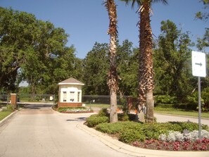 Enter a serene oasis surrounded by lush gardens and tall palm trees.