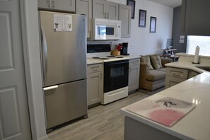Prepare meals in the fully equipped kitchen with stainless steel appliances and enjoy dining in the adjacent seating area.