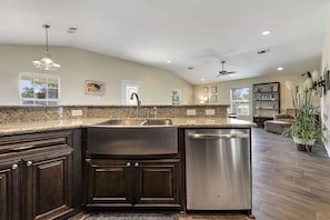 Enjoy cooking in this well-equipped kitchen with a large island, sink, and dishwasher.