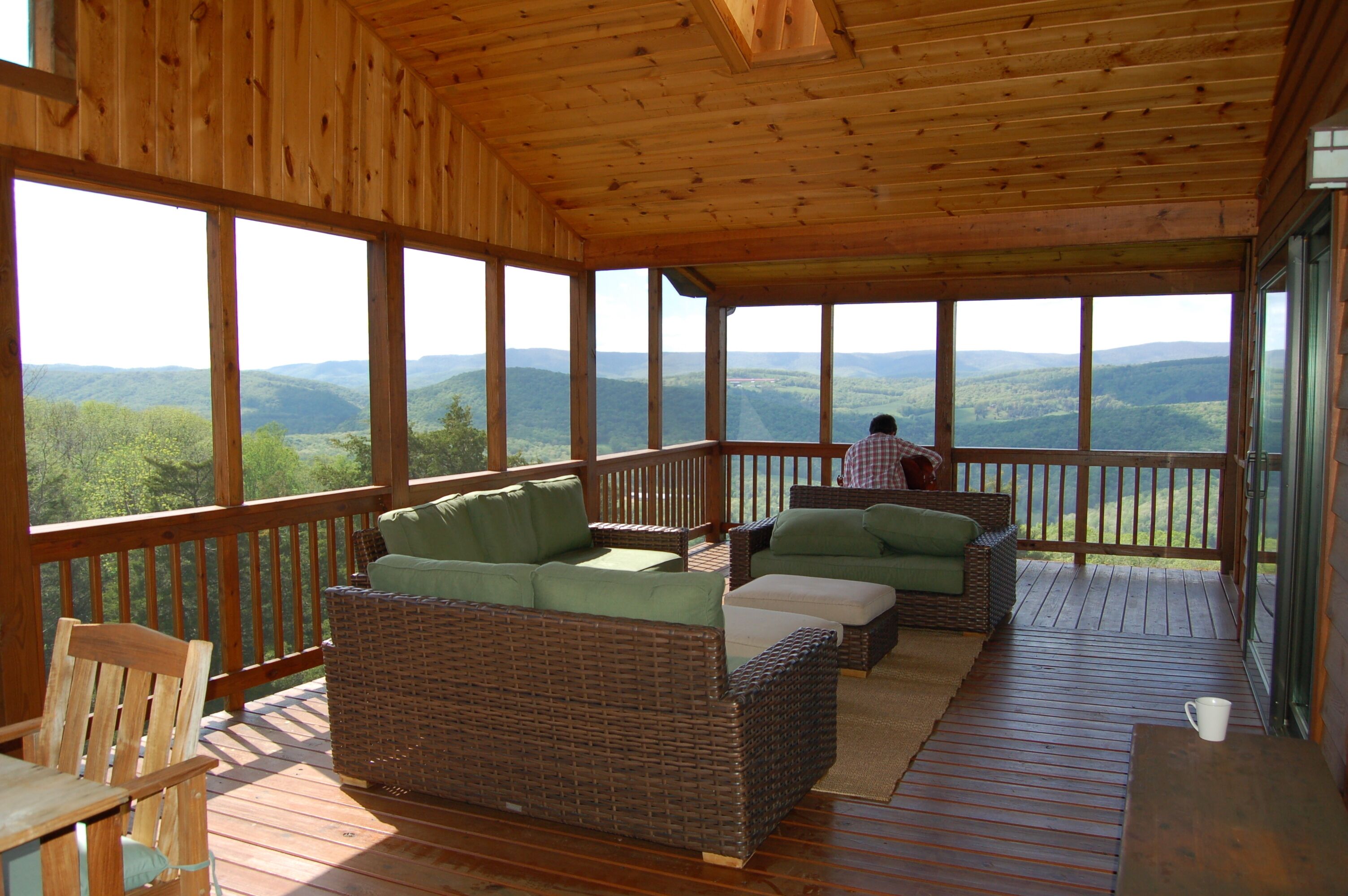 A guest playing guitar on the upstairs covered porch.