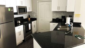 Microwave, dishwasher, coffee/tea maker, cookware/dishes/utensils