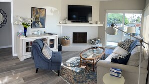 A modern living room with a fireplace, a television, and a sofa. - Ocean View!  4 Minute Walk To Beach!  Walk to Everything! (San Clemente)