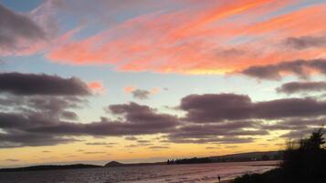 A beach with a sunset sky.