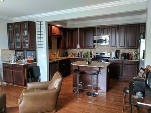Enjoy casual dining at the central island with bar stools, or cook up a meal in the well-equipped kitchen with a microwave, oven, and coffee maker.