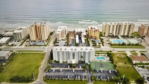A coastal hotel complex with multiple high-rise buildings, a parking lot, and a swimming pool. - Sunny Days N Daytona @ Ocean Terrace Club. Family friendly. Ocean & River views (Daytona Beach Shores)