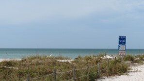 A beach with a sign indicating beach access and regulations. - Berm Bay un 22 Gorgeous Townhouse , White Sandy Beaches, elevator, heated pool (Bradenton Beach)