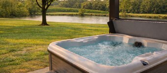 Relax at a cozy countryside retreat with a private hot tub, pond views & fire pit — pure bliss.
