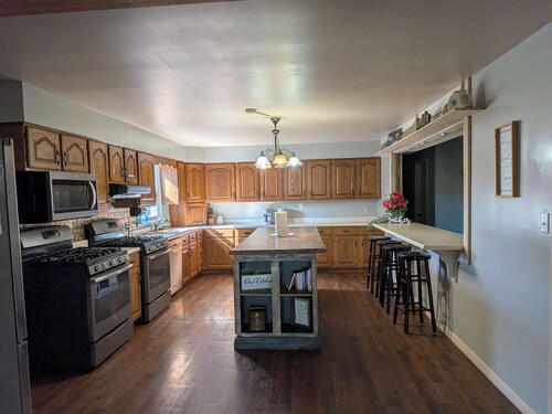 Relax at a cozy countryside retreat with a private hot tub, pond views & fire pit — pure bliss.