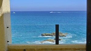 A view of the ocean through a window with a stone balustrade. - Casa Mar Azul, a Stunning Oceanfront Condo (Cabo San Lucas)