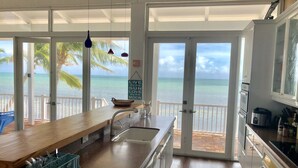 A kitchen with a view of the ocean, a wooden counter, and a sink. - Beach Dream House, relax and enjoy the clear waters of Islamorada  FL  (Islamorada)
