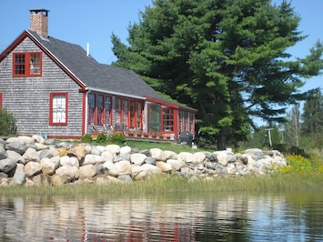 The deck and back of the cottage from the water.