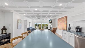 A modern kitchen with a long countertop, white cabinets, and a built-in oven. - Beachfront 3 BR condo in Diamond Beach with pool - Completely renovated for 2024 (Wildwood)