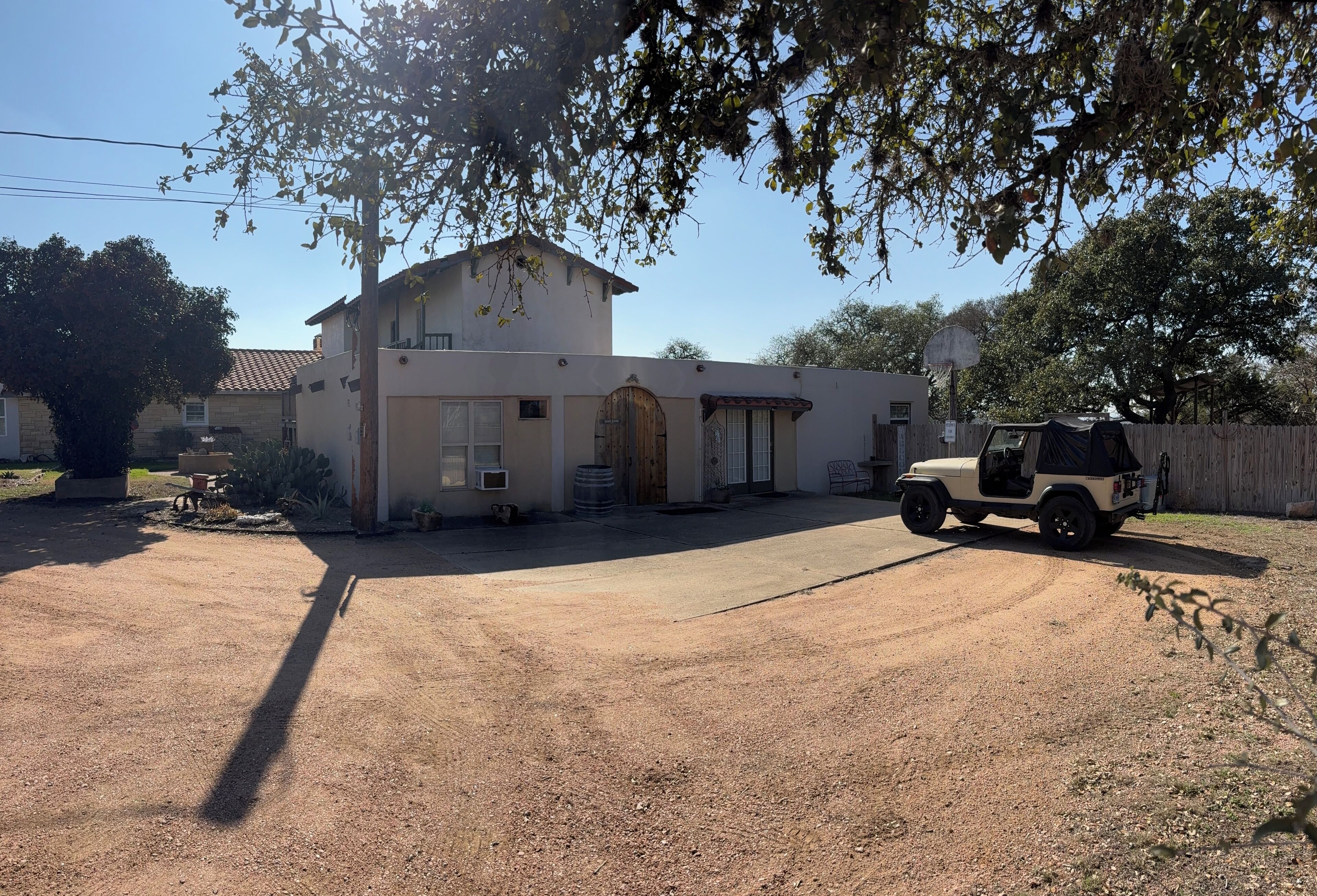 A two-story house with a driveway and a parked vehicle.